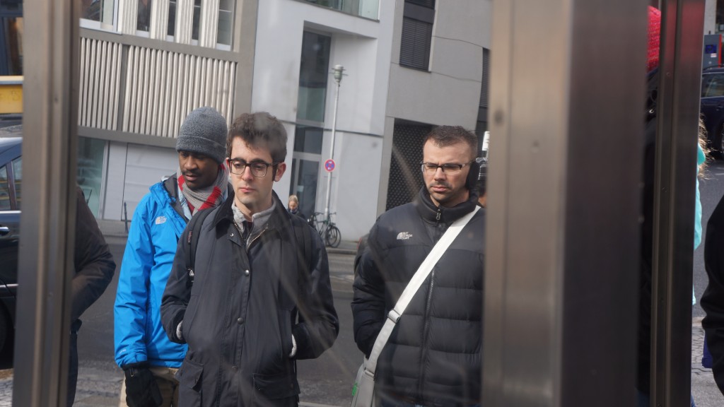 Ben, Matthew, and Patricio somberly examine a memorial to Jewish businesses in the fashion/clothing industry, outside of the Hausvogteiplatz U Bahn.