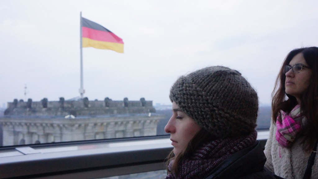 Hannah Grace and Kyra in the Reichstag dome, German flag in the background.